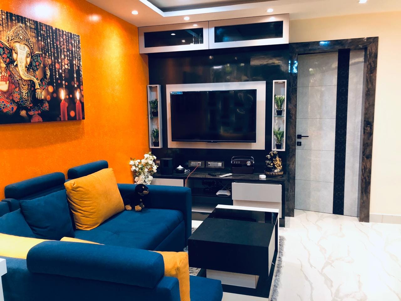 Living area with blue sofa and accent wall